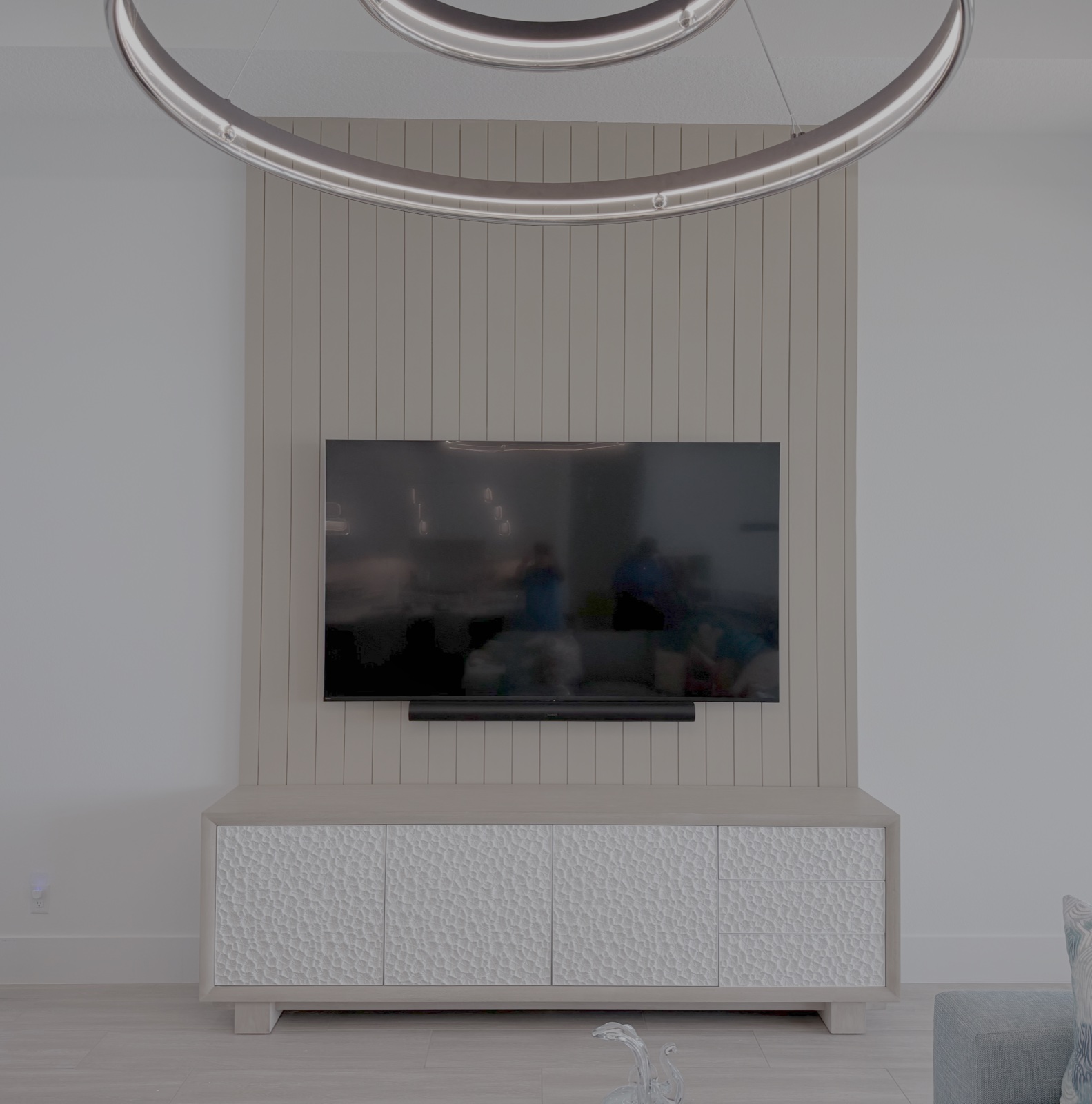 Designer white vertical slat accent wall with floating entertainment credenza in Bradenton Florida