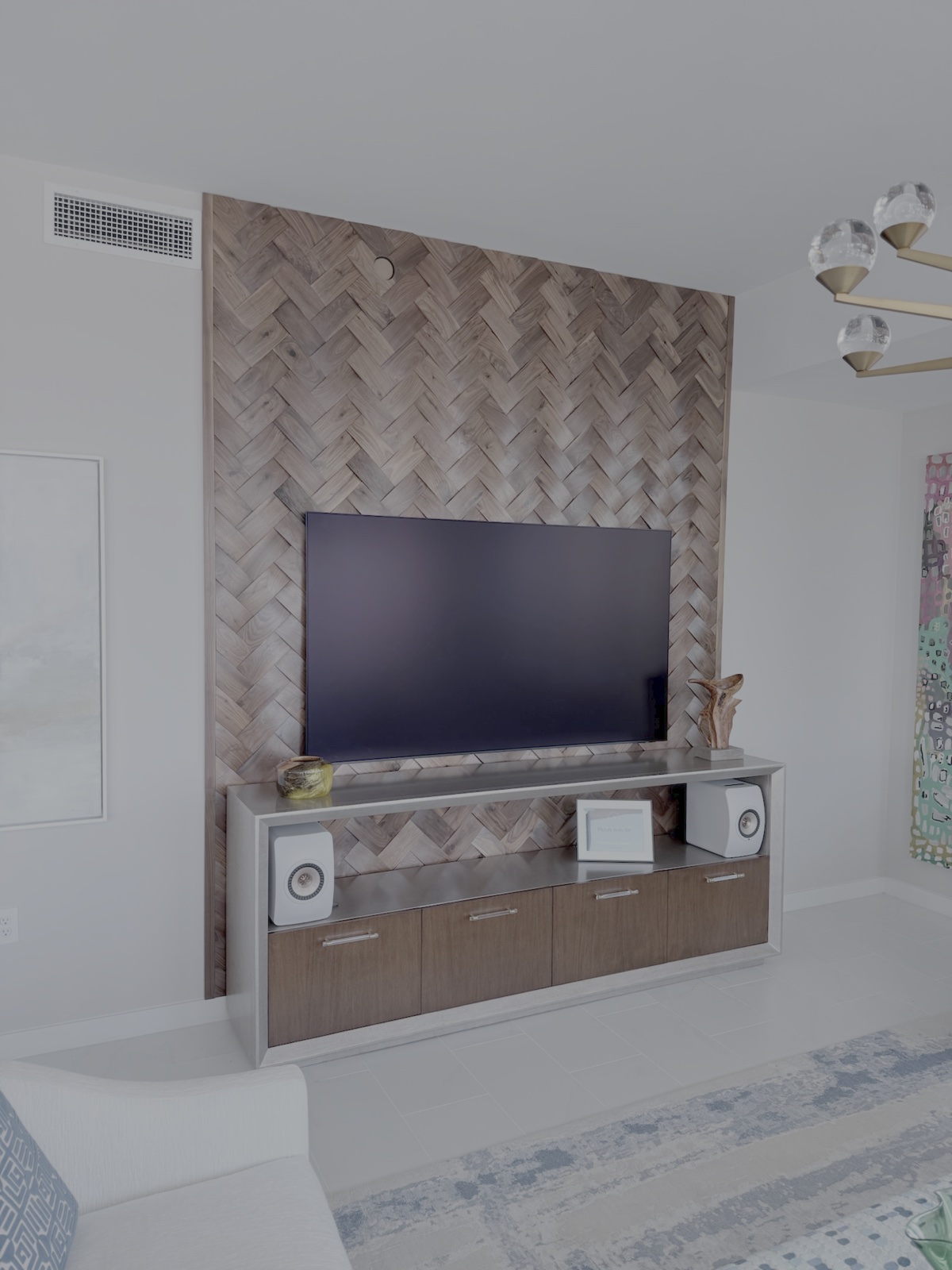 Handcrafted geometric herringbone wood accent wall plank by plank in Sarasota Florida