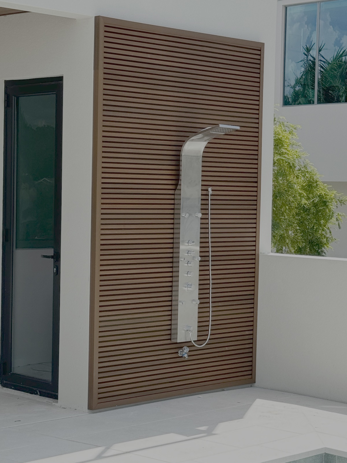 Custom architectural horizontal louvered wood privacy wall for luxury outdoor shower in Anna Maria Island FL